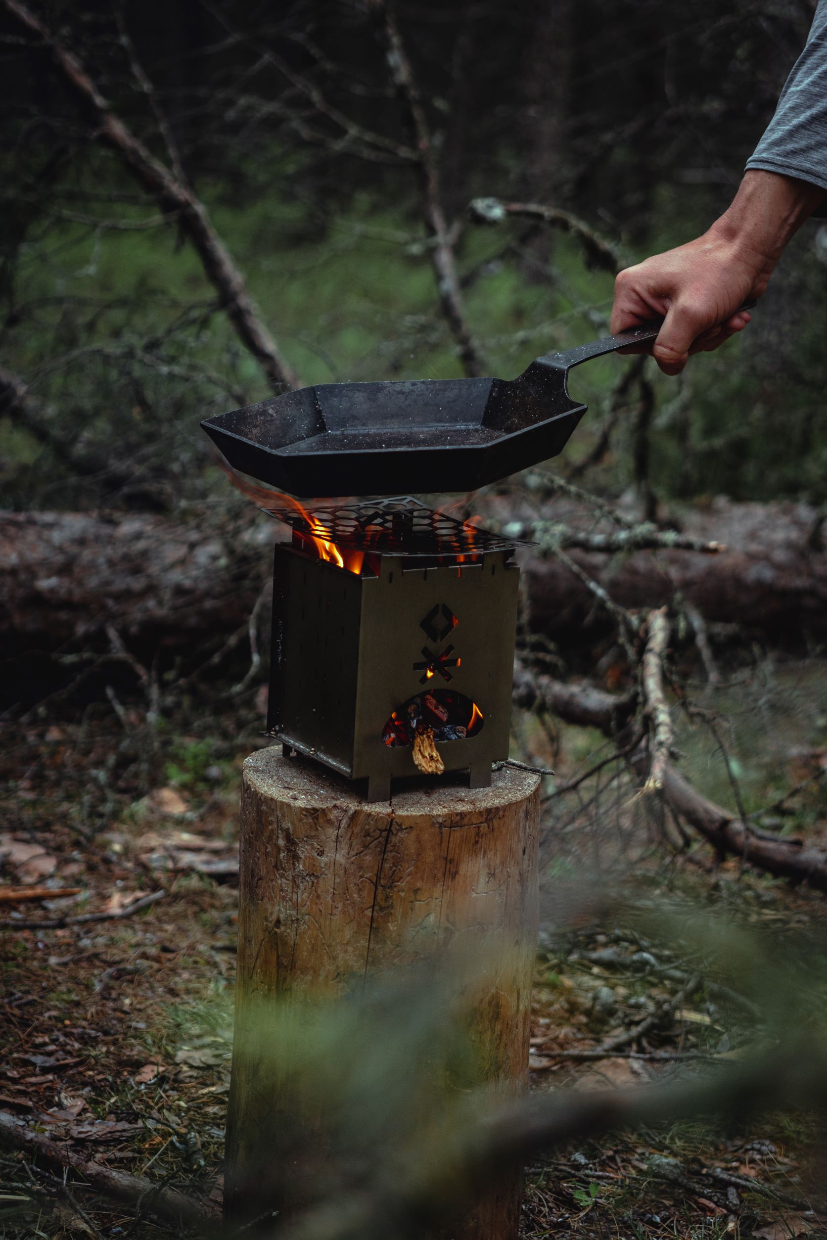 Hex Firepan being lowered onto heated Tinderbox grill